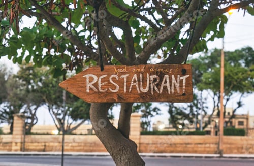 Preview: Rustic Restaurant Sign on Tree in an Outdoor Urban Setting