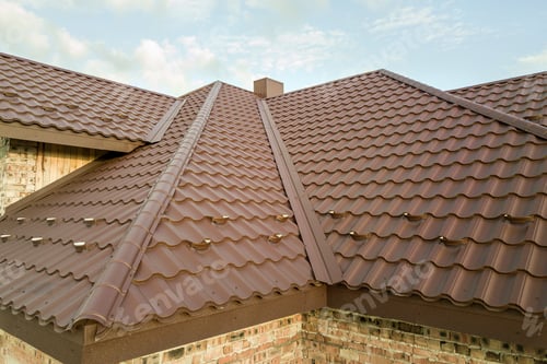 Preview: Detail of house roof structure covered with brown metal tile sheets