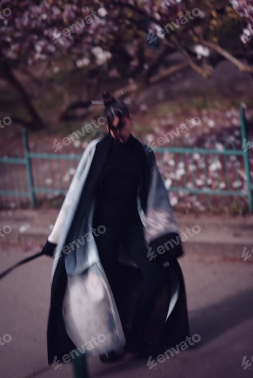 Preview: Beautiful young woman wearing kimono with cherry blossoms, sakura view