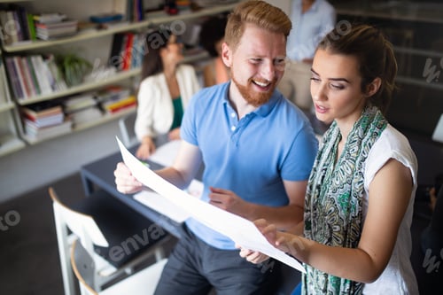 Preview: Team of colleagues brainstorming together while working in modern office