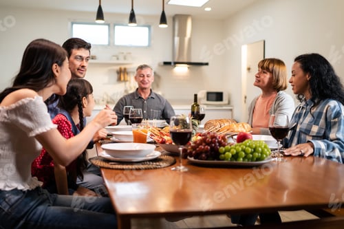 Preview: Multi-ethnic big family having dinner, enjoy evening party in house.