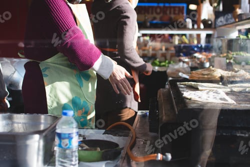 Preview: Woman cooking Turkish gozleme on a market