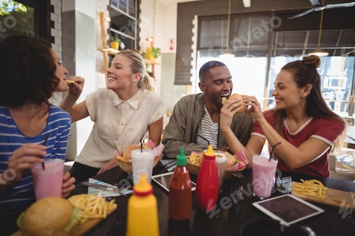 Preview: Young friends sharing food at coffee shop