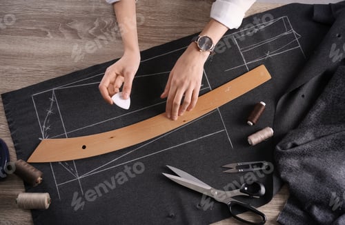 Preview: Tailor working at table in atelier, top view