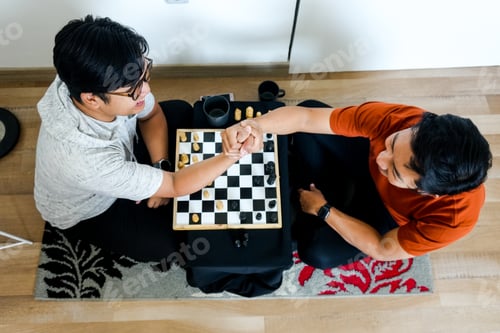Preview: Friends Celebrate Chess Victory With Handshake