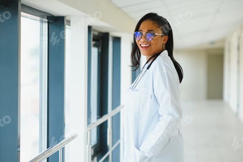 Preview: Smiling Woman Doctor with Stethoscope in Hospital Hallway