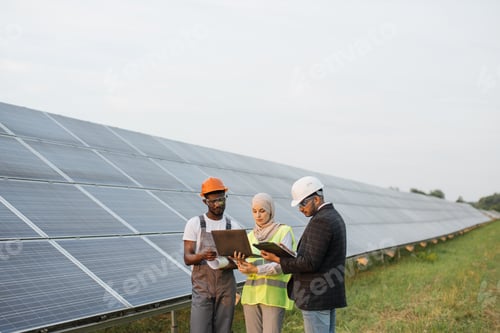 Preview: Two inspectors and technician talking on solar farm
