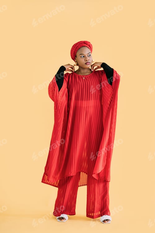 Preview: Full length portrait of pretty African woman wearing red fashionable red suit and head wrap scarf