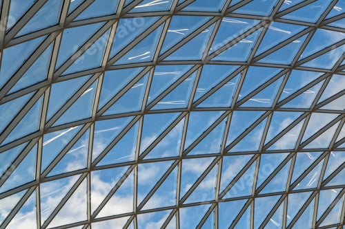 Preview: glass ceiling dome in a modern shopping center against a blue sky