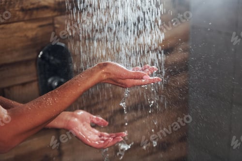 Preview: Close up view of hands of woman that taking a shower in spa