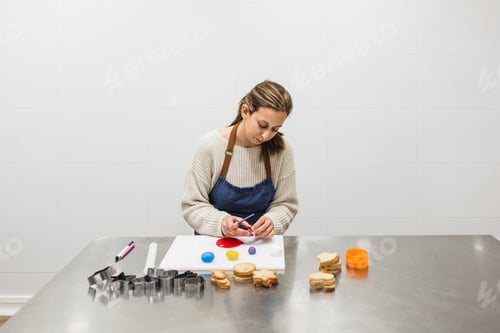 Preview: Pastry chef painting colored doughs for cookie decoration