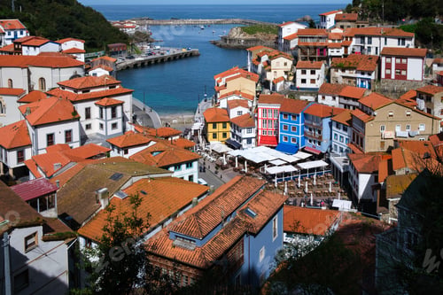 Preview: A city with numerous red rooftops line the shore of a body of water, showcasing the traditional arch