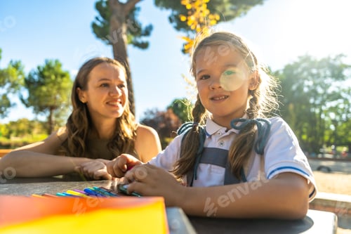 Preview: Mother and daughter drawing outdoors at school