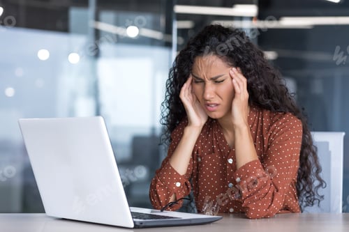 Preview: Sick and overtired Latin American business woman working inside office buildin