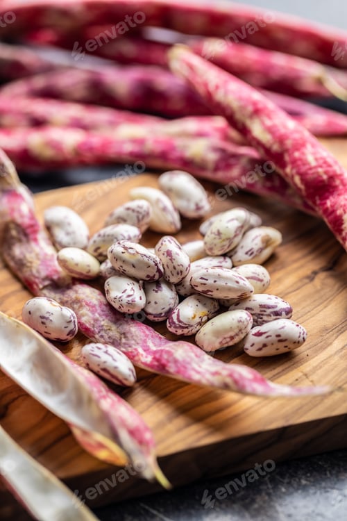 Preview: Cranberry beans. Beans pods on cutting board.