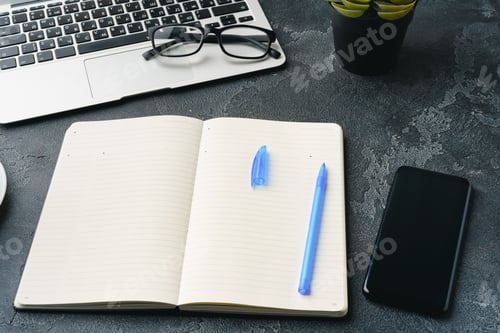 Preview: Blank notebook with pen are on top of office desk table