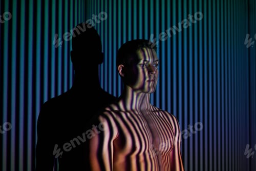 Preview: Into the mind of the man. Studio shot of a young man posing against abstract lighting.