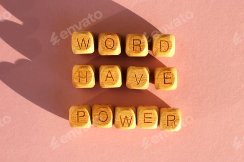 Preview: wooden cubes with the inscription world have power on a pink background. selective focus