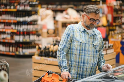 Preview: Senior man at grocery store products