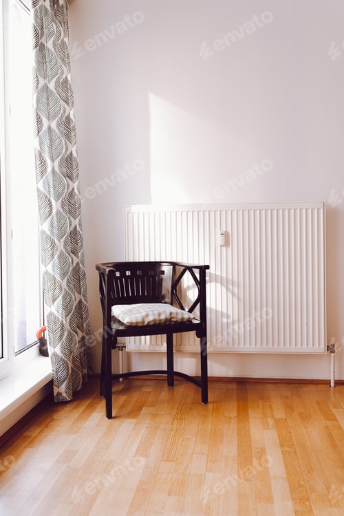 Preview: Cozy new apartment with an antique wooden chair, white wall and large window