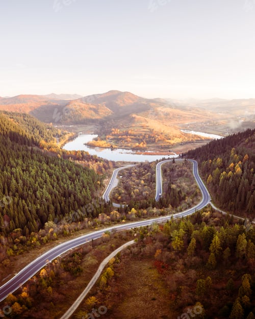 Preview: Flight over the autumn mountains with mountain road serpentine
