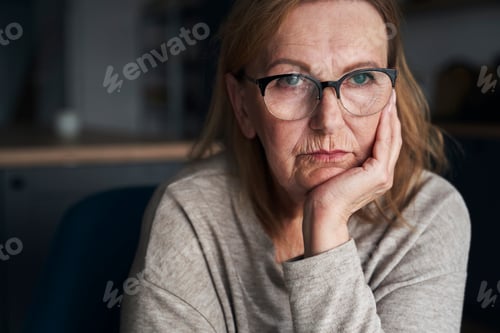Preview: Miserable and thoughtful caucasian senior woman looking away