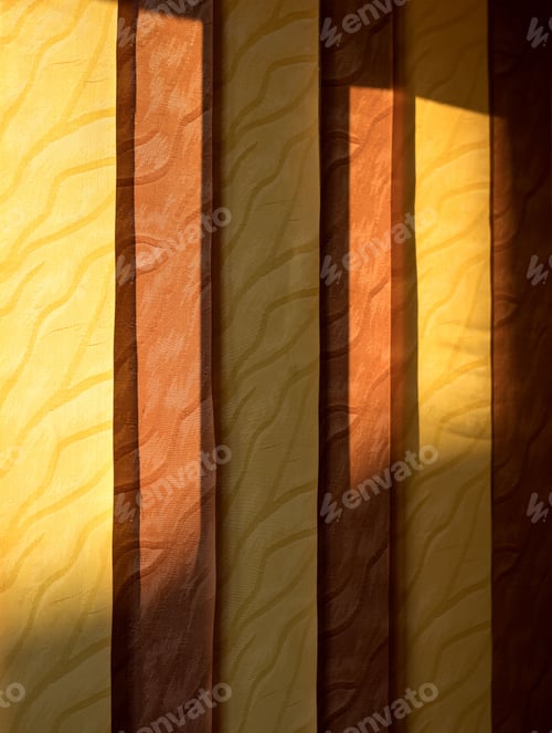 Preview: Vertical shot of an orange yellow curtain illuminated by the light