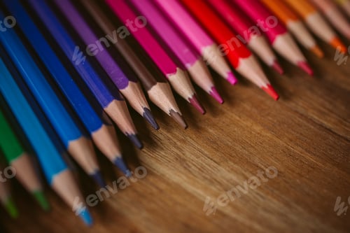 Preview: Colored pencils on wooden background with selective focus. Back to school and education concept.