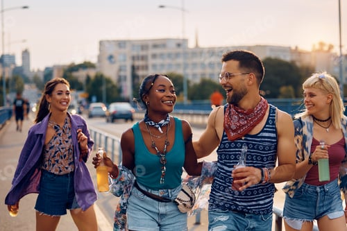 Preview: Young happy friends enjoying in summer day while going to a music concert.