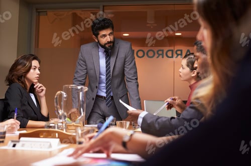 Preview: Businessman addressing team at a meeting, low angle close up