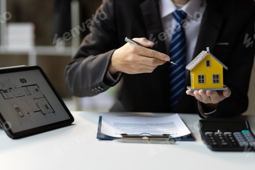 Preview: Real estate agent is offering a home to a client to sign a home purchase agreement.