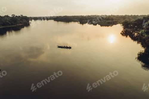 Preview: Sunset on the Amazon river. Boat with people on the water.