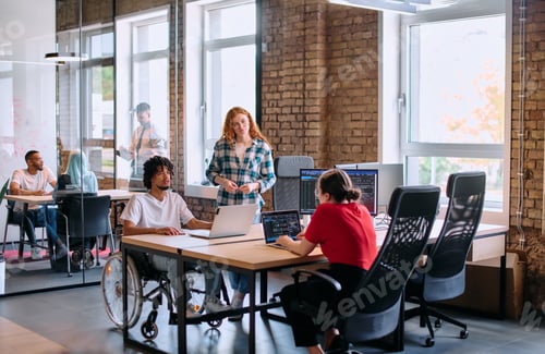 Preview: A diverse group of business professionals collaborates in a modern startup coworking center