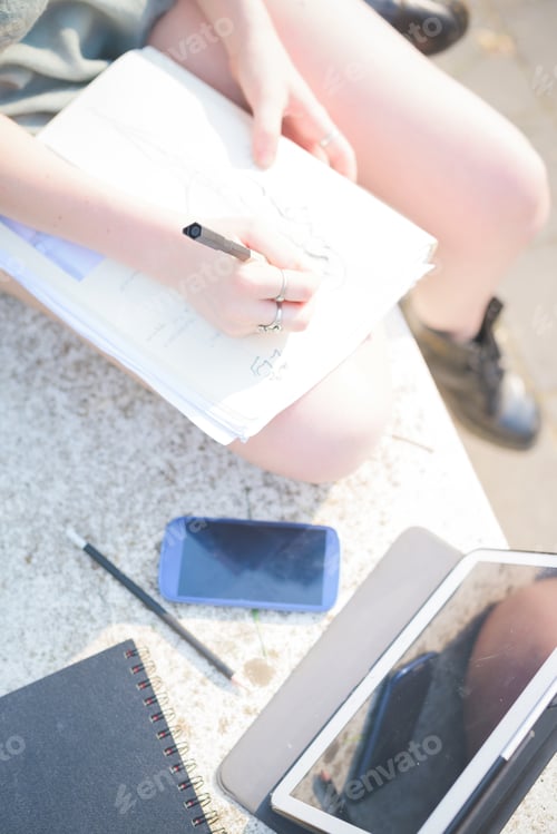Preview: Young woman sketching using technology