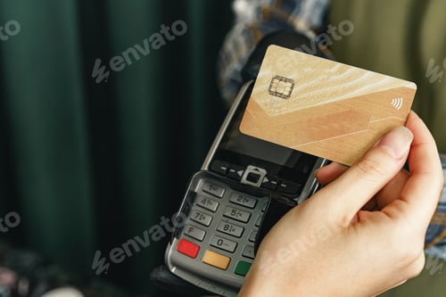 Preview: Customer using credit card for payment at cafe or shop by terminal with nfc cashless technology