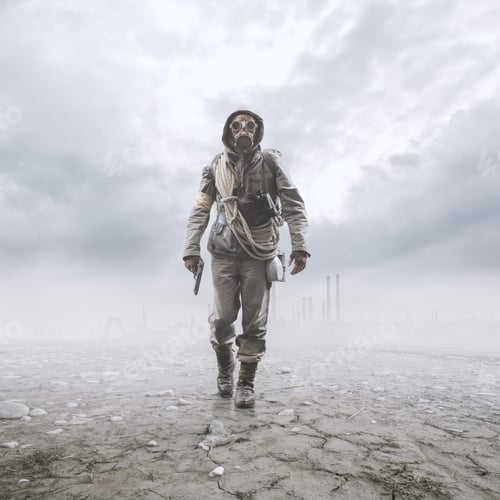 Brave soldier with gas mask walking in a post atomic landscape