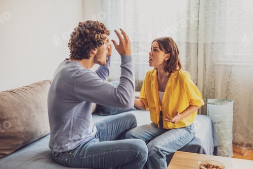 Frustrated Man and Woman Arguing on Couch
