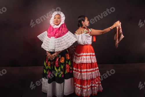 Preview: Two women in traditional Mexican clothing pose for a photo