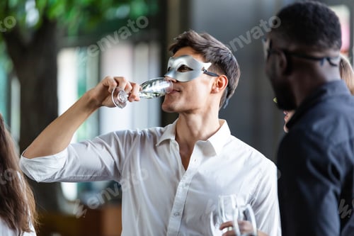 Preview: Diversity office worker in fancy mask having celebration party