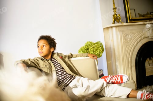 Preview: Portrait of boy reclining on sitting room sofa