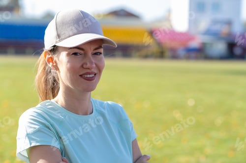 Preview: A young beautiful woman in sportswear plays sports at a local stadium