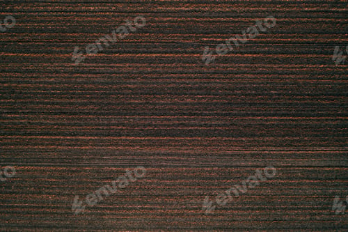 Preview: Aerial view of plowed field from drone pov