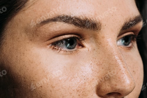 Preview: close up view of beautiful girl with freckles on face