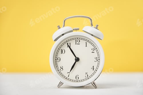 Preview: Time concept. White retro alarm clock on yellow background with copy space. Time concept