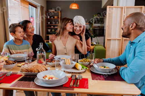 Preview: Multi-generational family enjoying a meal together at home