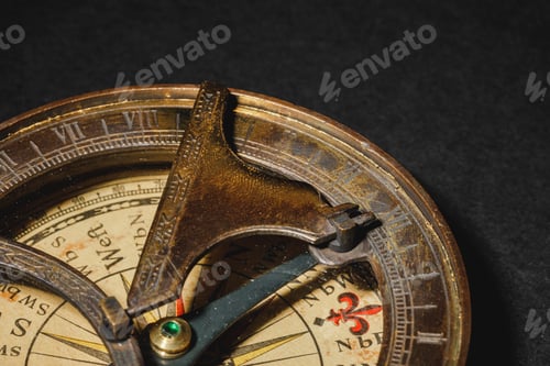 Preview: Retro compass on black board background. Close up.