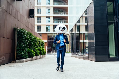 Preview: Storytelling image of a business man wearing a giant panda head