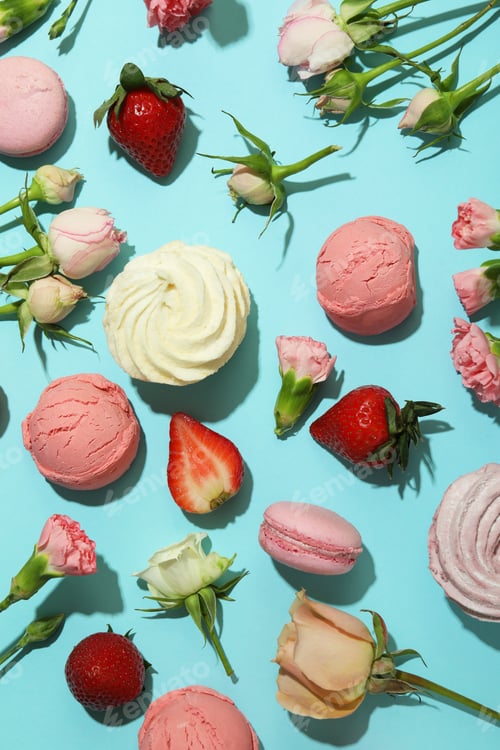 Preview: Macaroons, marshmallows, flowers and strawberry on blue background