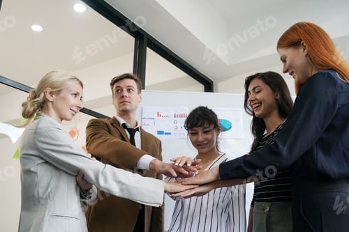 Preview: Diverse young coworkers colleagues discussing project at desk in modern office.