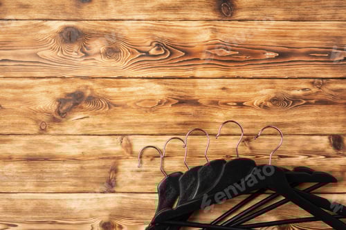 Preview: Clothes Hangers on a Wooden Background